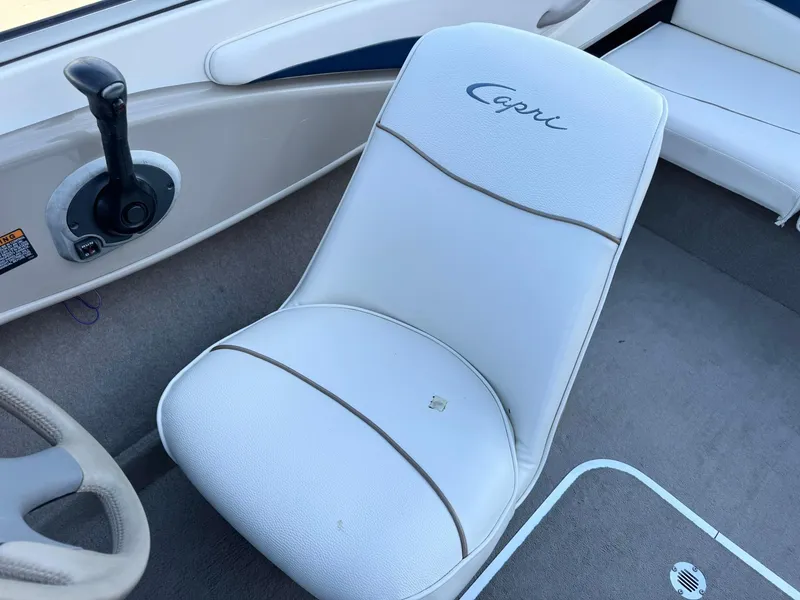 Slide: The Image of 2002 Bayliner 185 BR boat interior with white Capri seat and steering controls. - 20
