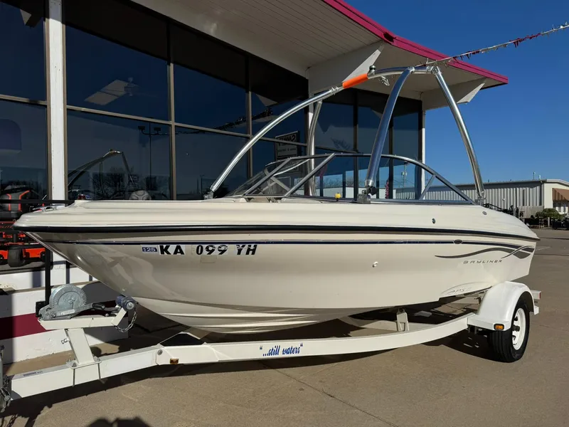 Slide: The Image of 2002 Bayliner 185 BR boat on trailer, parked outside a building. - 3