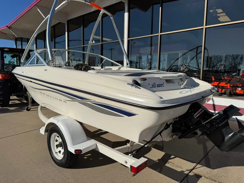 Slide: The Image of 2002 Bayliner 185 BR boat on trailer, parked outside a showroom. - 5