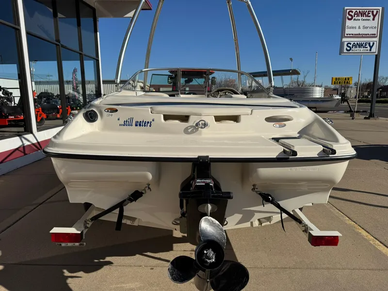 Slide: The Image of 2002 Bayliner 185 BR boat displayed at a dealership, rear view. - 6