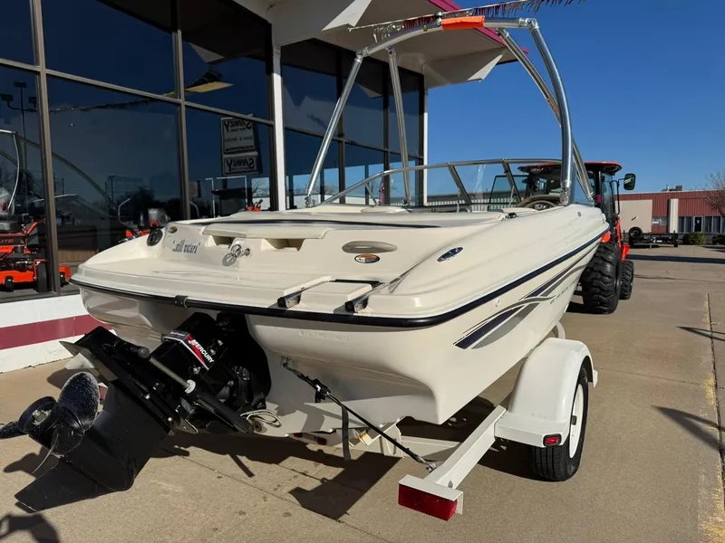 Slide: The Image of 2002 Bayliner 185 BR boat on trailer, parked outdoors in sunny weather. - 7