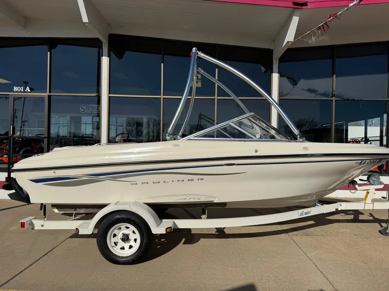 Slide: The Image of 2002 Bayliner 185 BR boat on trailer, parked outside a building. - 9