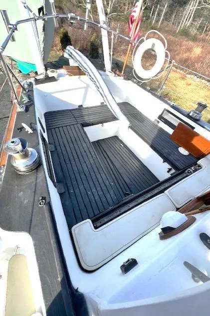 Slide: The Image of 1980 Kaiser Gale Force 34 sailboat cockpit with wooden flooring and steering wheel. - 17