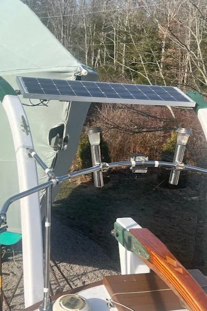 Slide: The Image of Solar panel on 1980 Kaiser Gale Force 34 sailboat, surrounded by trees and equipment. - 21