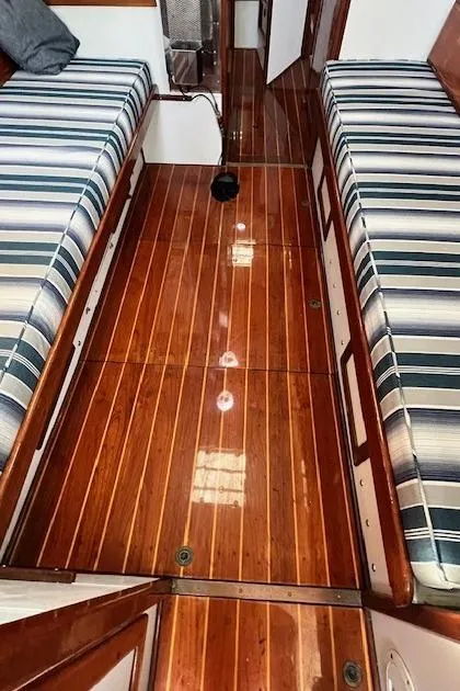 Slide: The Image of Interior of 1980 Kaiser Gale Force 34 with polished wood flooring and striped seating. - 27