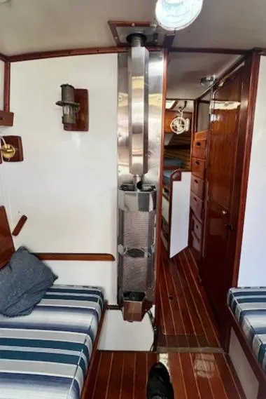 Slide: The Image of Interior of 1980 Kaiser Gale Force 34 sailboat with striped seating and wooden finishes. - 28