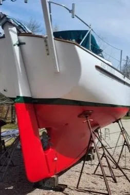 Slide: The Image of 1980 Kaiser Gale Force 34 sailboat on stands, showcasing red hull and white upper body. - 3