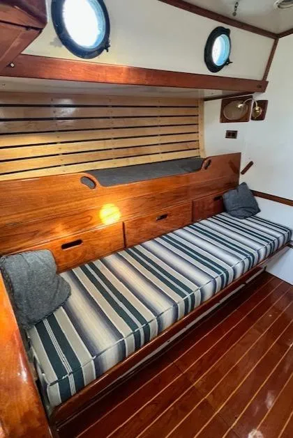Slide: The Image of 1980 Kaiser Gale Force 34 interior with striped cushions and wooden accents. - 31