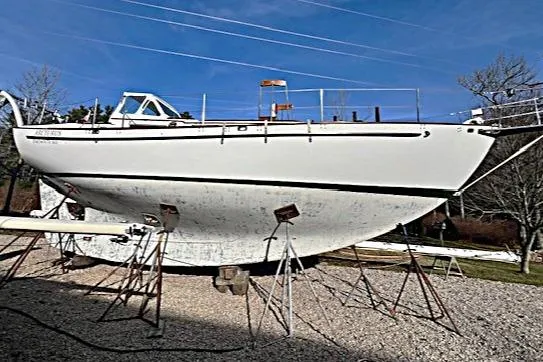 Slide: The Image of 1980 Kaiser Gale Force 34 sailboat on stands, displayed outdoors under clear blue sky. - 4