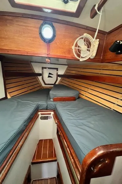 Slide: The Image of 1980 Kaiser Gale Force 34 sailboat cabin with wooden interior and cozy sleeping area. - 41