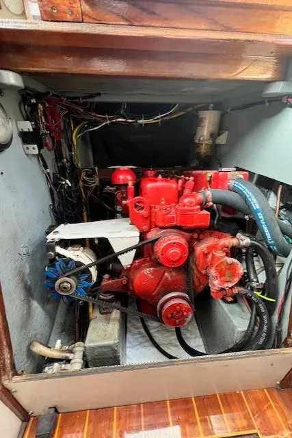 Slide: The Image of Engine compartment of 1980 Kaiser Gale Force 34 sailboat, featuring a red engine and wiring. - 46