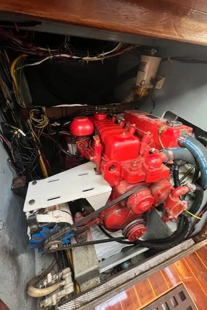 Slide: The Image of Engine compartment of a 1980 Kaiser Gale Force 34 sailboat, featuring a red engine. - 47