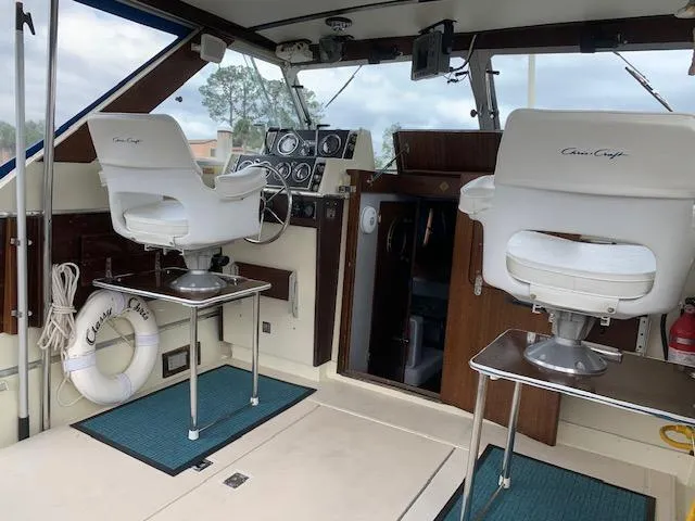 Slide: The Image of 1968 Chris-Craft 31 Commander boat interior with helm chairs and dashboard. - 12