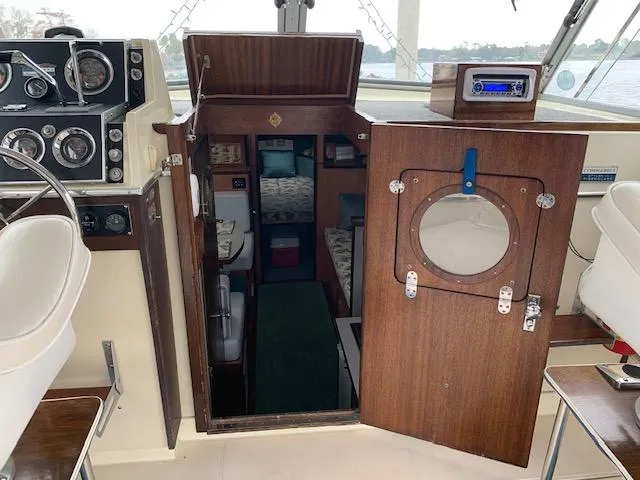 Slide: The Image of 1968 Chris-Craft 31 Commander cabin interior with vintage controls and wooden door. - 13