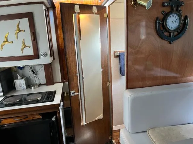 Slide: The Image of Interior of 1968 Chris-Craft 31 Commander with kitchenette and nautical decor. - 16