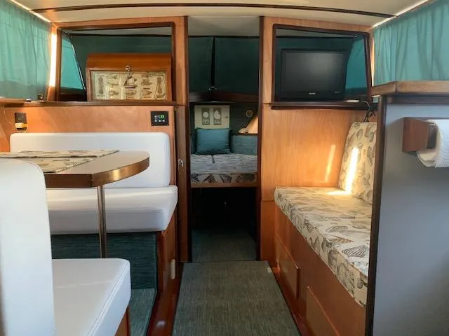 Slide: The Image of Interior of a 1968 Chris-Craft 31 Commander boat with seating and a small TV. - 6