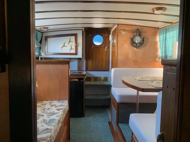 Slide: The Image of Interior of a 1968 Chris-Craft 31 Commander boat with wood paneling and seating area. - 8