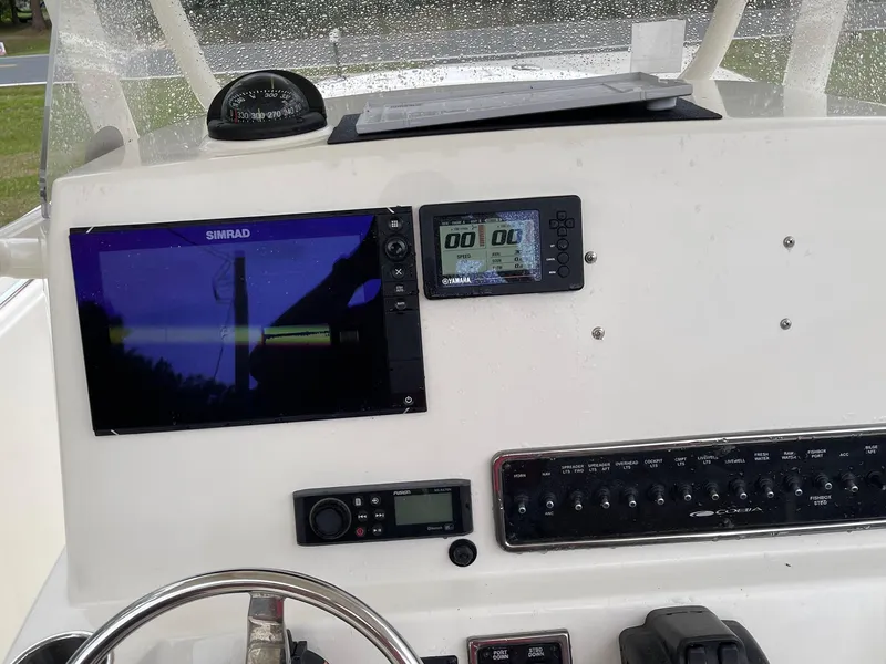 Slide: The Image of Dashboard of 2017 Cobia 261 Center Console with navigation and control panels. - 24
