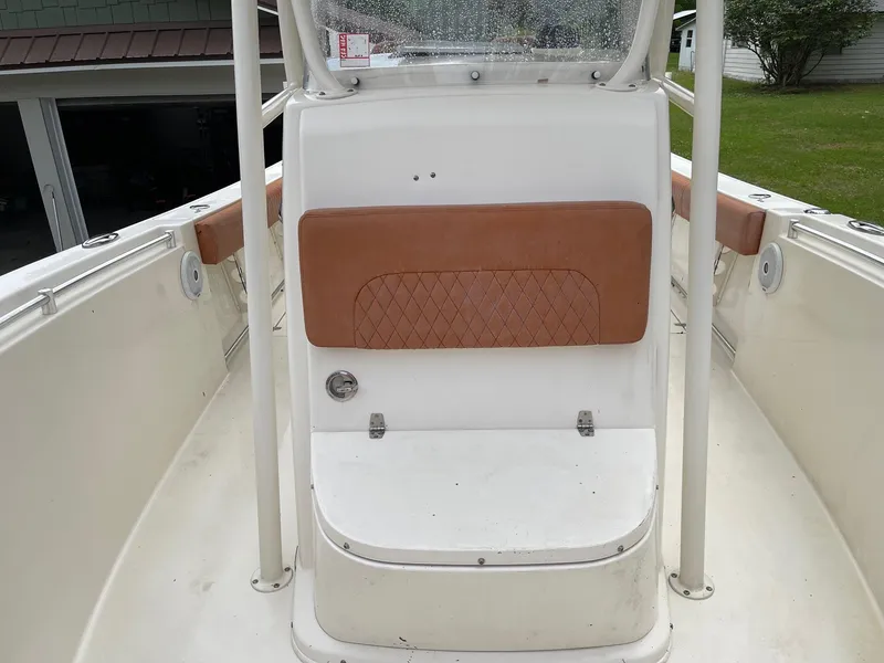 Slide: The Image of 2017 Cobia 261 Center Console boat interior with tan seating and white deck. - 28
