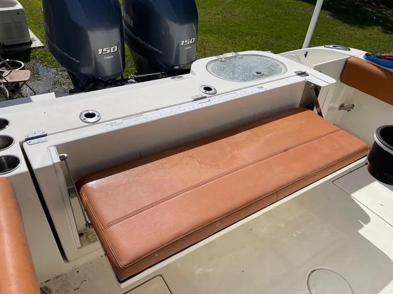 Slide: The Image of 2017 Cobia 261 Center Console boat with dual 150 engines and cushioned seating. - 29