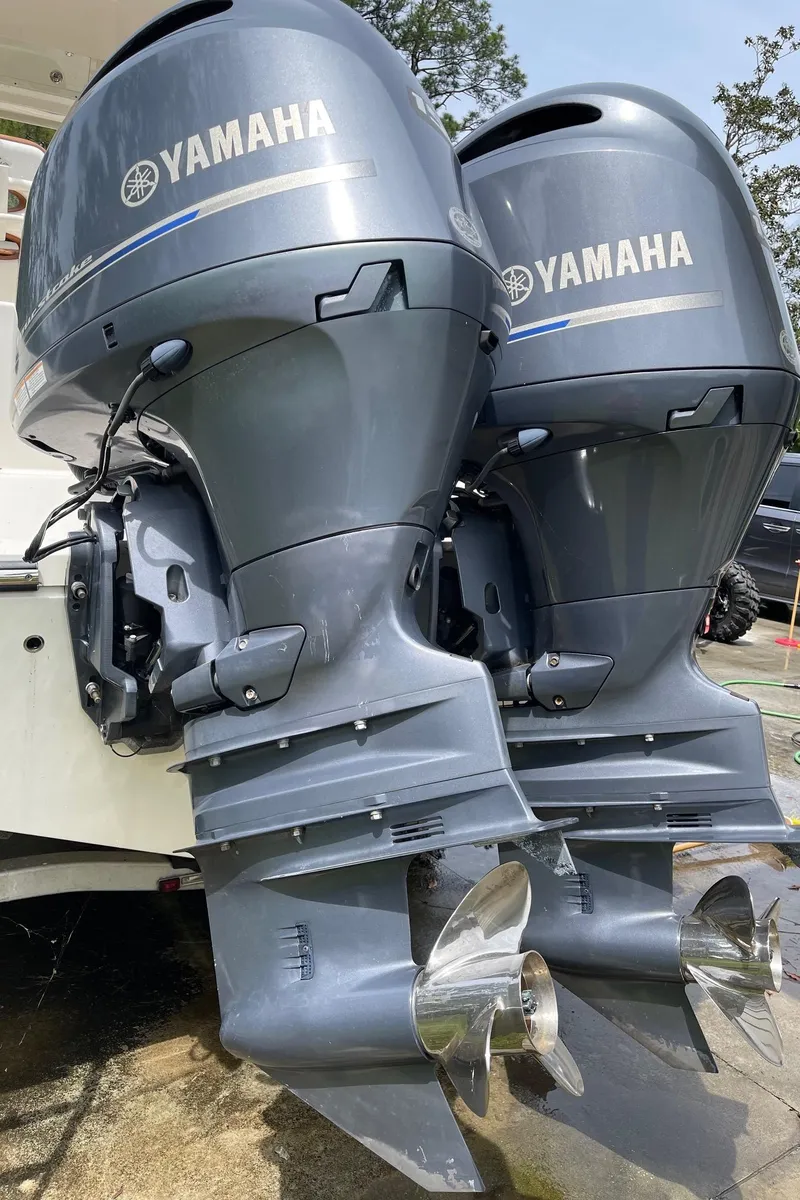 Slide: The Image of Twin Yamaha outboard motors on a 2017 Cobia 261 Center Console boat. - 30