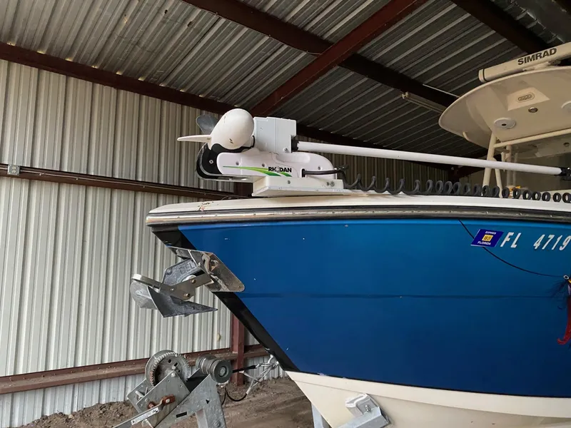 Slide: The Image of 2017 Cobia 261 Center Console boat in storage, featuring a blue hull and advanced equipment. - 31