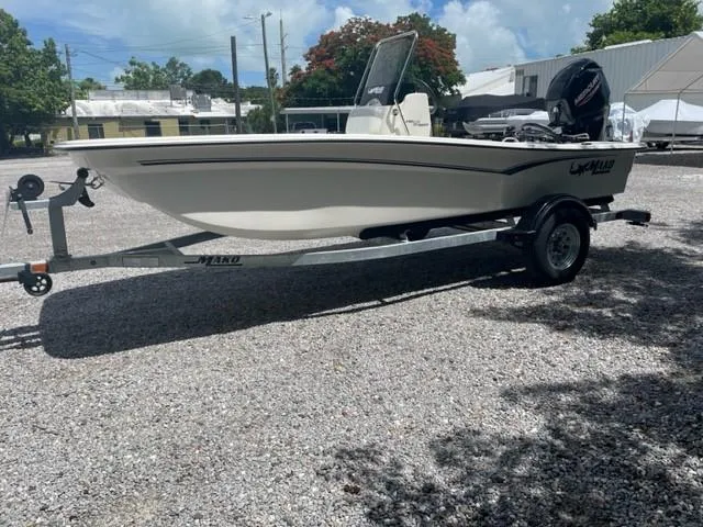 Slide: The Image of 2025 Mako Pro Skiff 17 CC boat on trailer, parked outdoors. - 2