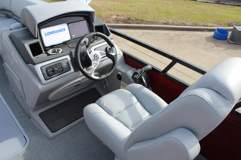 Slide: The Image of 2025 Regency 230 DL3 pontoon boat with spacious gray seating and sleek design. - 11