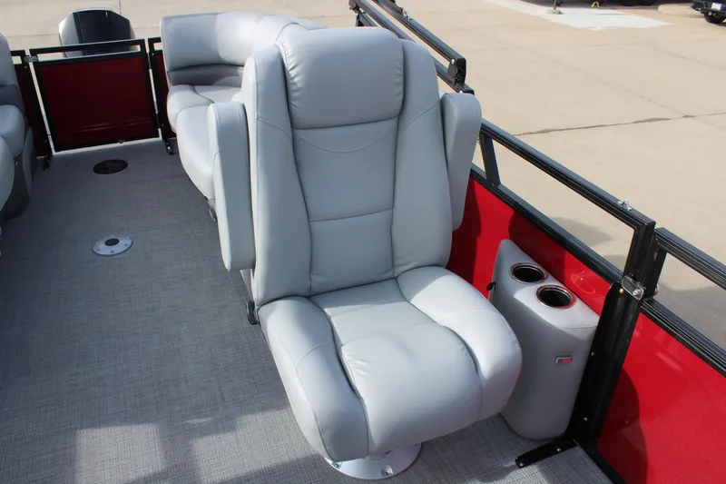 Slide: The Image of 2025 Regency 230 DL3 pontoon boat interior with gray seating and red paneling. - 14