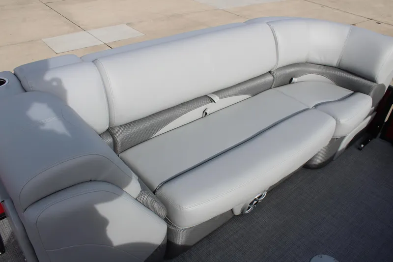 Slide: The Image of Luxurious seating on 2025 Regency 230 DL3 pontoon boat with red accents. - 15