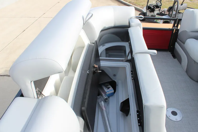 Slide: The Image of 2025 Regency 230 DL3 boat storage compartment with open lid, showcasing spacious interior. - 19