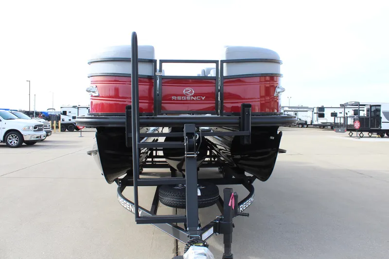 Slide: The Image of 2025 Regency 230 DL3 pontoon boat with red exterior and black trim on a trailer. - 2