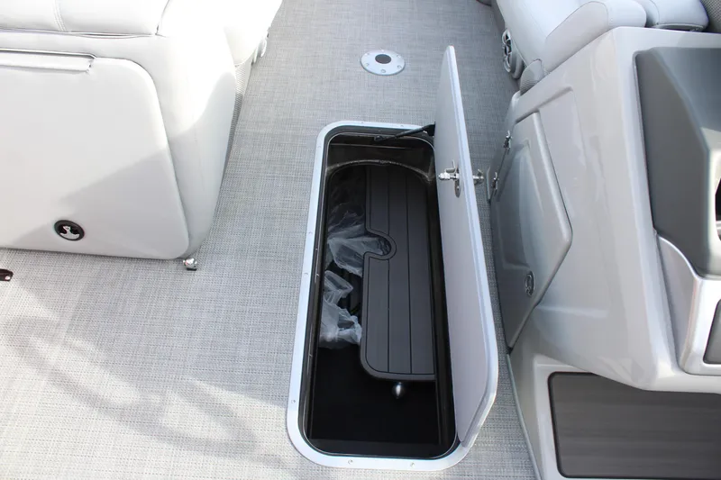 Slide: The Image of 2025 Regency 230 DL3 boat interior storage compartment with open seat. - 21