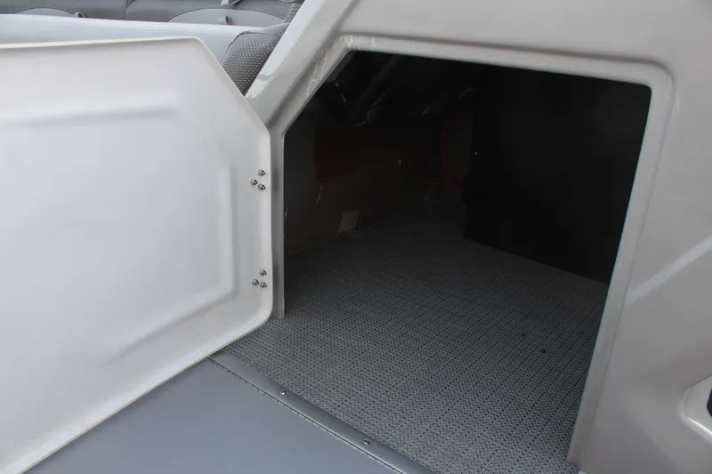 Slide: The Image of Open storage compartment on 2025 Regency 230 DL3 boat interior. - 22