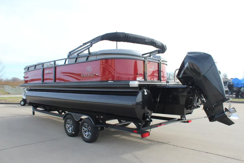 Slide: The Image of 2025 Regency 230 DL3 pontoon boat with red exterior at dealership, American flag in background. - 5