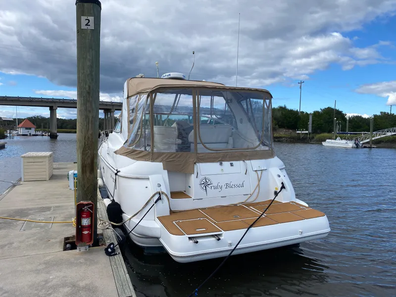 The Image of 2000 Cruisers 3672 yacht docked at marina under cloudy sky. - 0