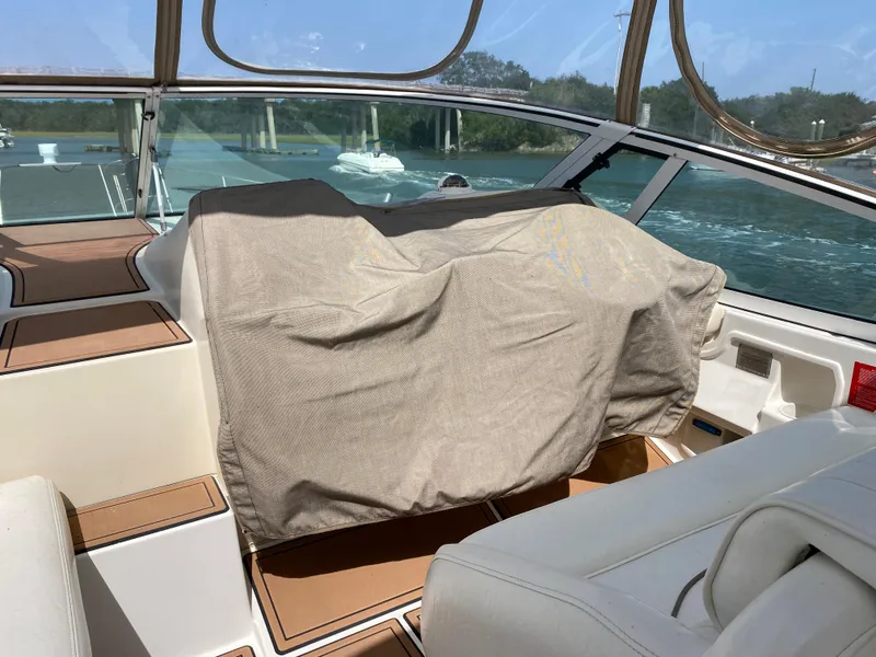 Slide: The Image of Cruisers 3672 yacht interior, 2000 model, with covered dashboard and scenic water view. - 10