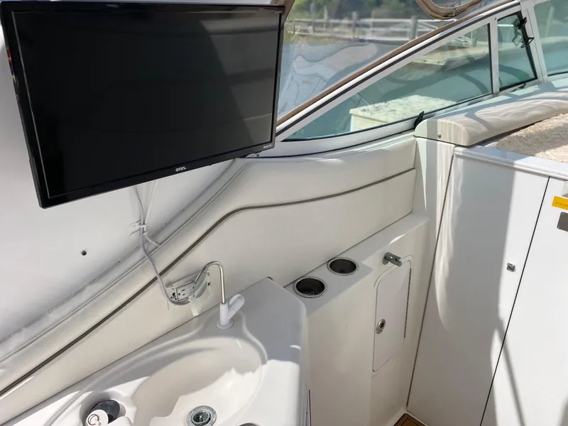 Slide: The Image of Interior of 2000 Cruisers 3672 yacht with sink, TV, and storage compartments. - 14