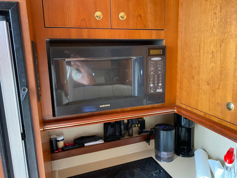 Slide: The Image of Microwave in 2000 Cruisers 3672 yacht kitchen with wooden cabinets. - 18