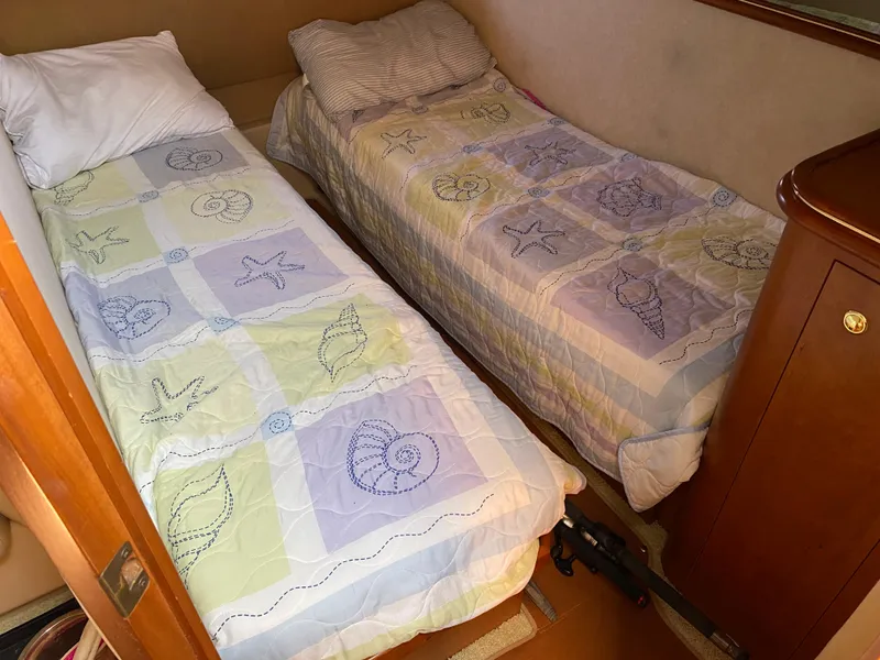 Slide: The Image of Twin beds with seashell-themed bedding in a 2000 Cruisers 3672 cabin. - 25
