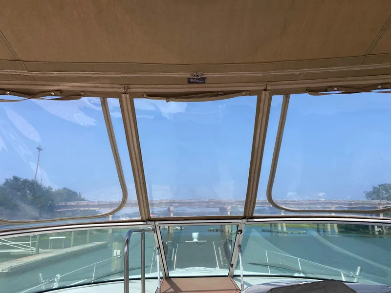 Slide: The Image of Interior view from a 2000 Cruisers 3672 yacht, showcasing the helm and clear blue sky. - 8