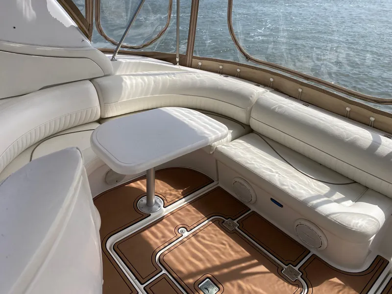 Slide: The Image of Luxurious 2000 Cruisers 3672 yacht interior with white leather seating and table. - 13