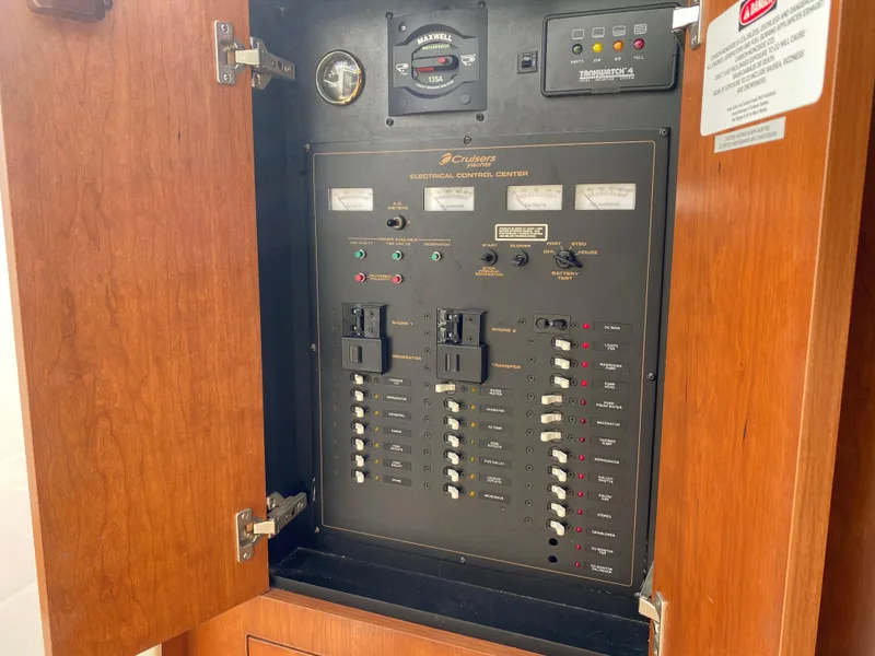 Slide: The Image of Electrical control panel inside a 2000 Cruisers 3672 boat, featuring switches and gauges. - 15
