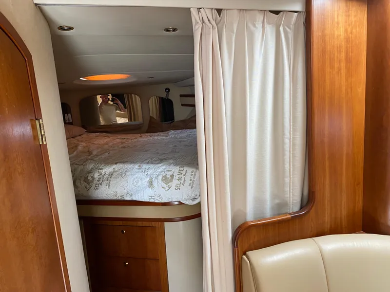 Slide: The Image of Interior of 2000 Cruisers 3672 yacht with cozy bedroom and wooden cabinetry. - 22