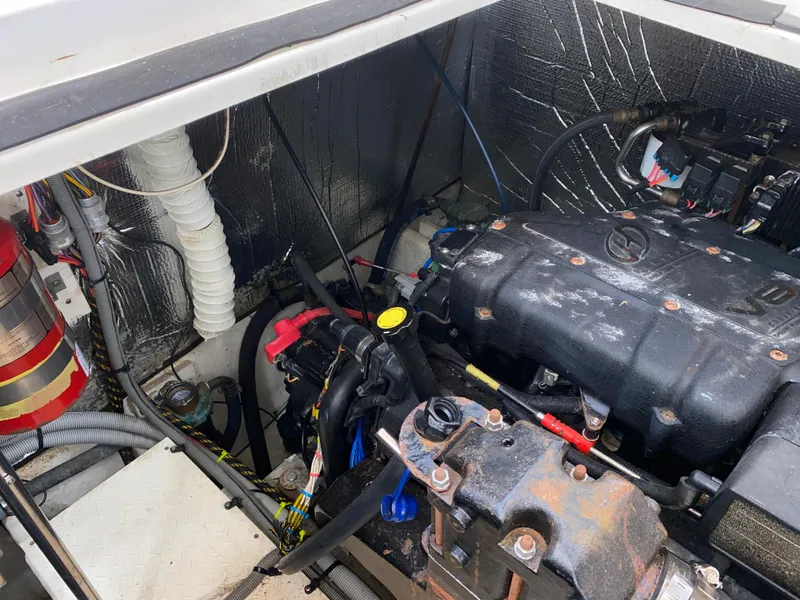 Slide: The Image of Engine compartment of a 2000 Cruisers 3672 boat, showing mechanical components and wiring. - 29