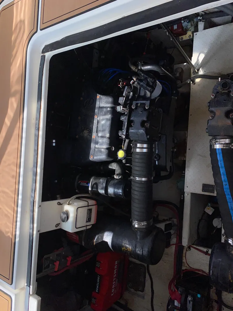 Slide: The Image of Engine compartment of a 2000 Cruisers 3672 boat, showcasing mechanical components. - 31