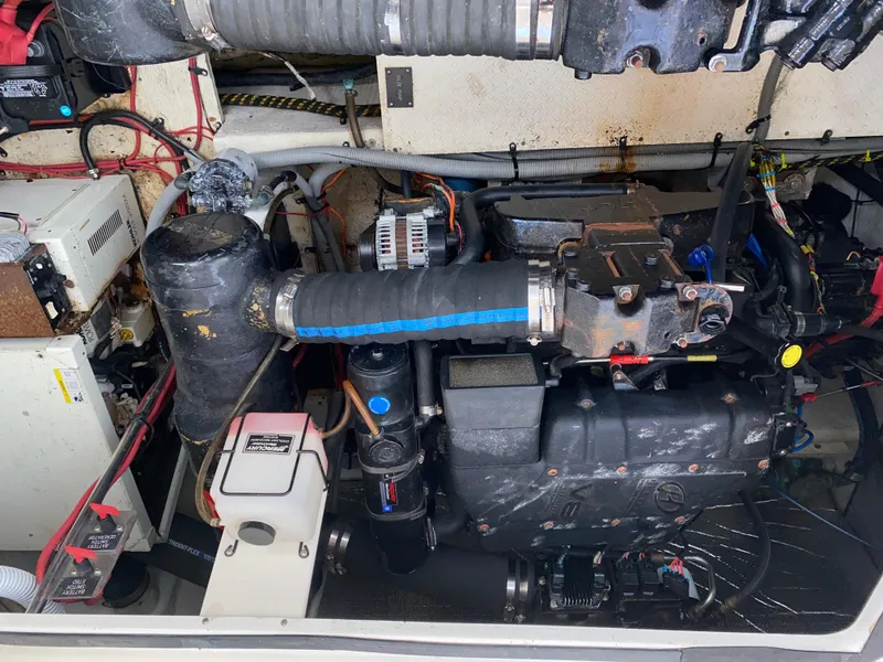 Slide: The Image of Engine compartment of a 2000 Cruisers 3672 boat, showing mechanical components and wiring. - 32