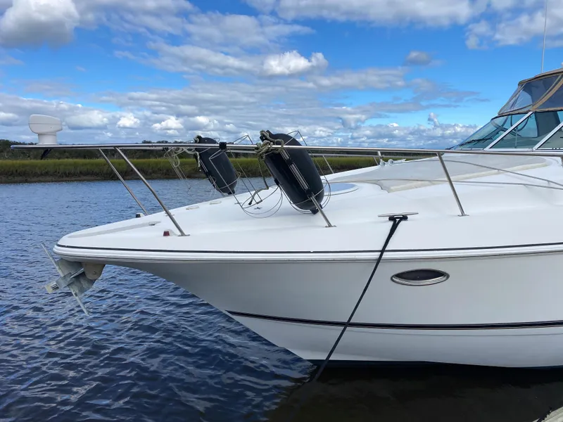 Slide: The Image of 2000 Cruisers 3672 yacht on calm water under a blue sky. - 5