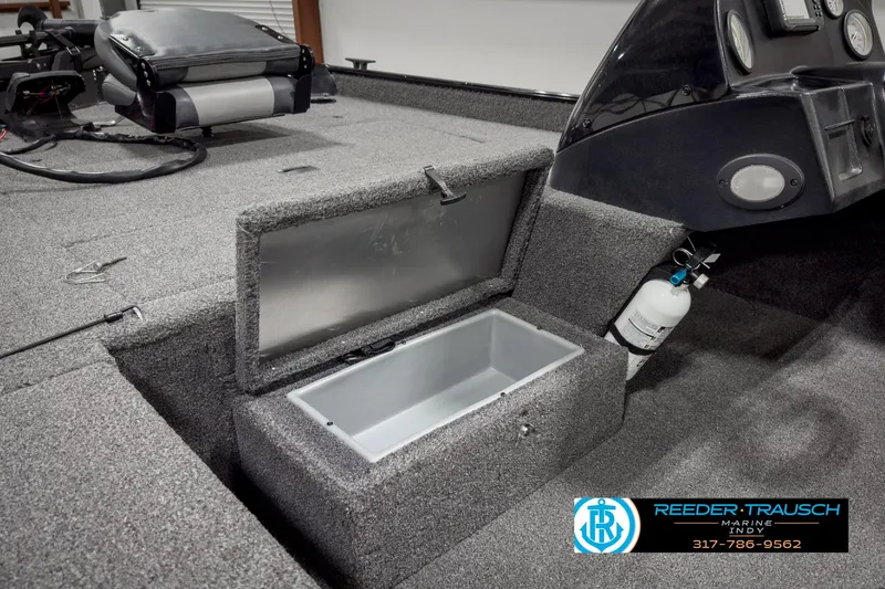 Slide: The Image of 2021 Lowe Skorpion 17 boat interior with open storage compartment and dashboard. - 16