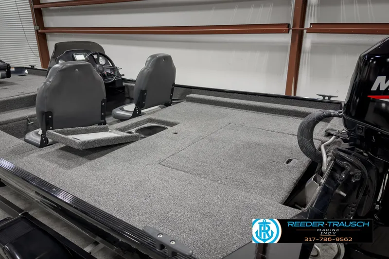 Slide: The Image of 2021 Lowe Skorpion 17 boat interior with dual seats and motor, displayed indoors. - 20